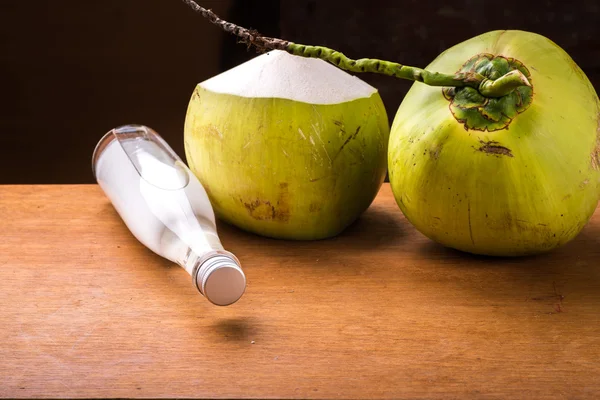 Bottle of Cold coconut oil on table. — Stock Photo, Image