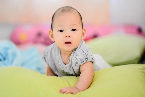 Happy Asian baby on bed. — Stock Photo, Image