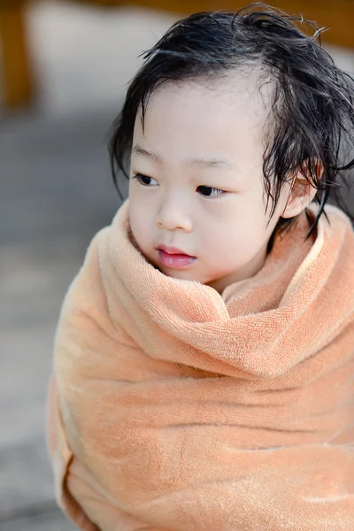 Wet Asian baby girl in brown towe. — Stock Photo, Image
