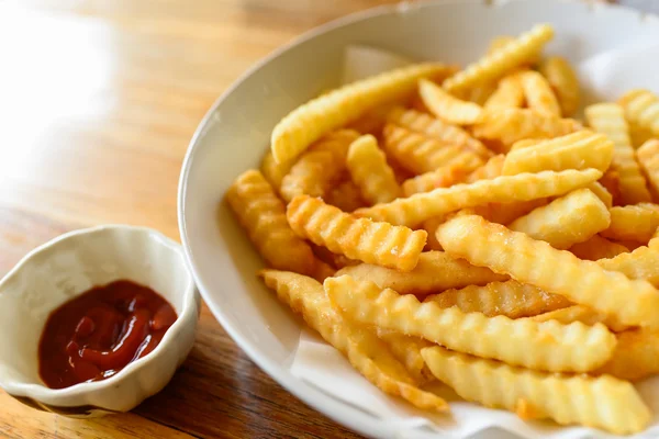 French fries closeup over wood — Stock Photo, Image