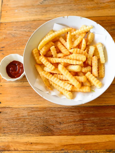 French fries closeup over wood — Stock Photo, Image