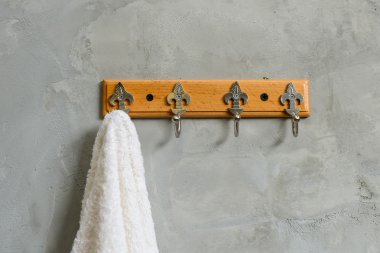 Hanging White Towel draped on Exposed Concrete Wall in the Bathr clipart