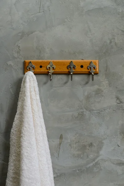 Hanging White Towel draped on Exposed Concrete Wall in the Bathr — Stock Photo, Image