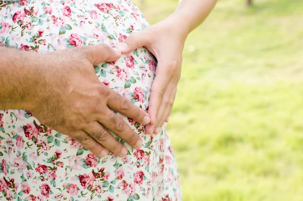 Casal grávida com forma de coração — Fotografia de Stock