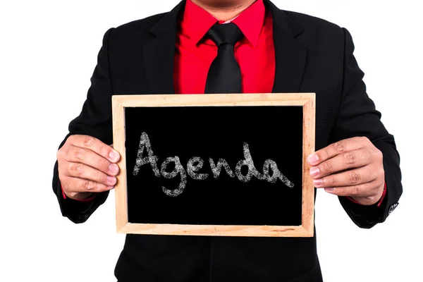 Empresario con palabra de agenda. Antecedentes Empresario sosteniendo b — Foto de Stock