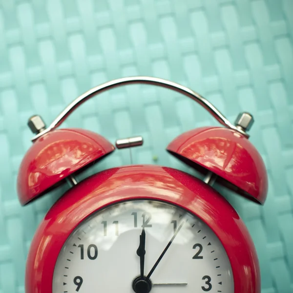 Retro alarm clock on blue texture background. — Stock Photo, Image