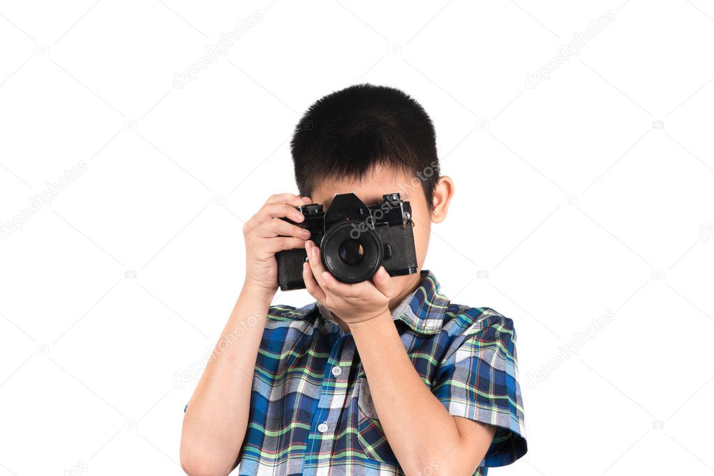 Handsome boy with an old camera isolated on white.