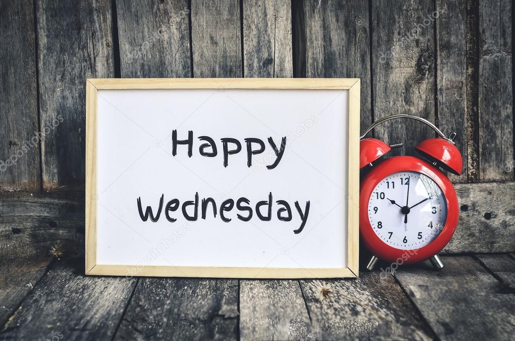 Happy Wednesday message on white board and red retro clock  by w