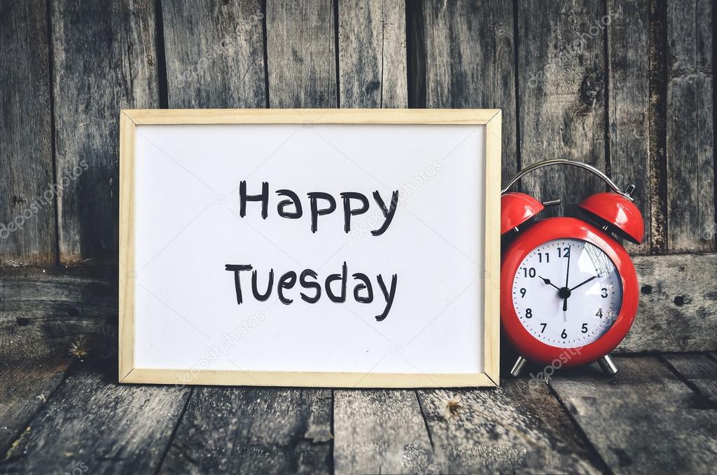Happy Tuesday message on white board and red retro clock  by woo