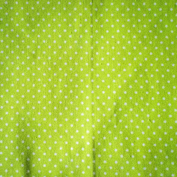 Білі крапки на зеленій тканині, вінтажний стиль . — стокове фото