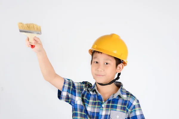 Asian boy in a protective helmet with brush in his hand — Stock Photo, Image