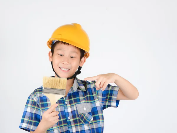 Asian boy in a protective helmet with brush in his hand — Stock Photo, Image