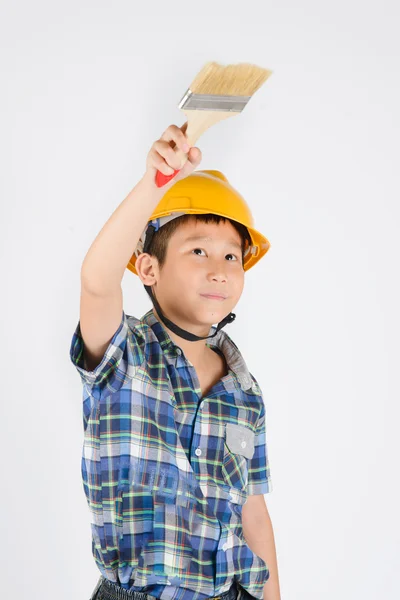 Asian boy in a protective helmet with brush in his hand — Stock Photo, Image