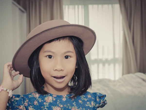 Happy Asian girl wearing hat and blue dress in room with vintage — Stock Photo, Image