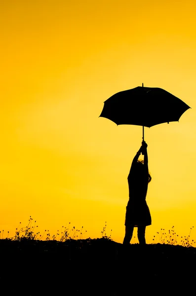 Umbrella girl with sunset silhouette — Stock Photo, Image