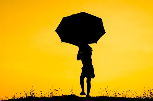 Umbrella girl with sunset silhouette — Stock Photo, Image