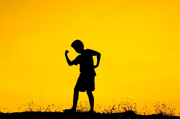 Boy raising his hands standing during sun set — Stock Photo, Image