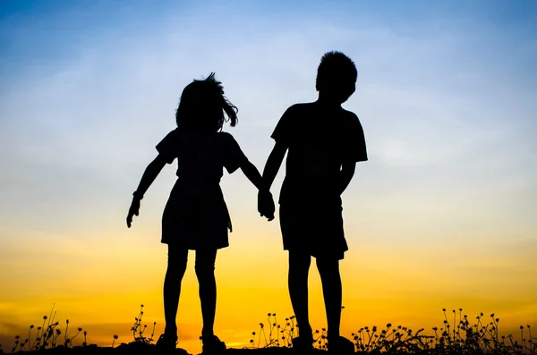 Little brother and sister silhouette — Stock Photo, Image