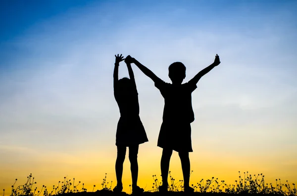 Little brother and sister silhouette — Stock Photo, Image