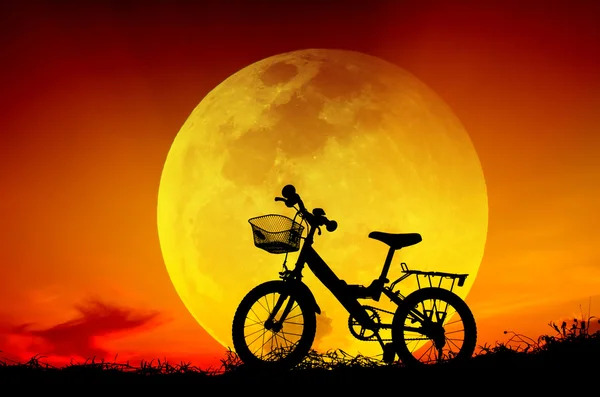 Bicycle silhouette with sun set and big moon. — Stock Photo, Image