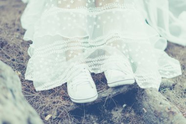 Bride 's legs in vintage tone.