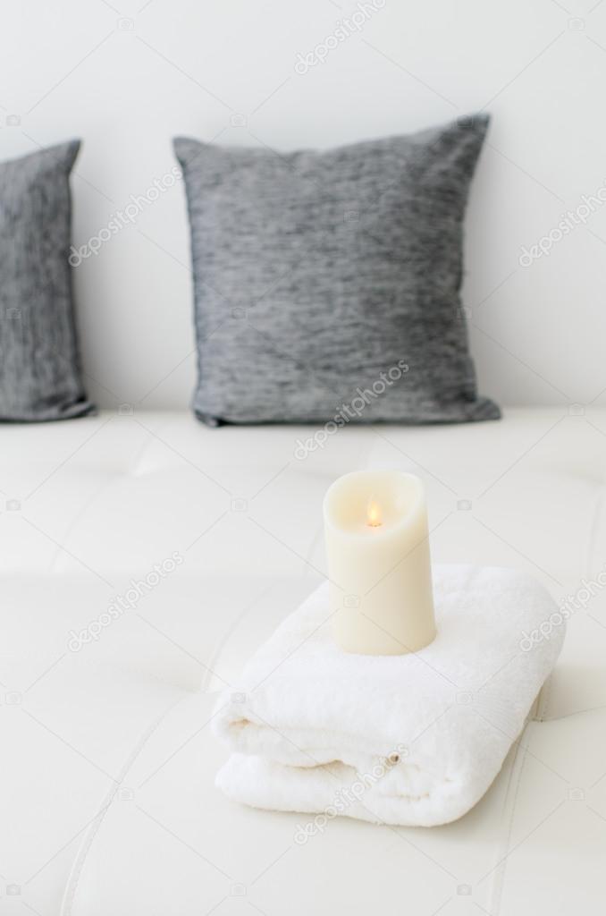 Candle on white towel