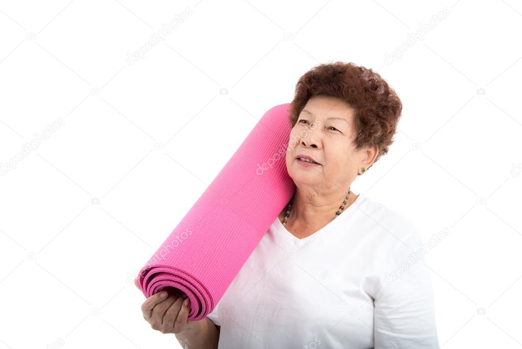 senior woman holding yoga mat