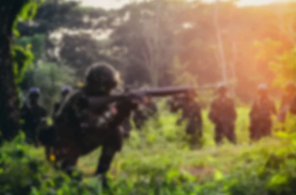 Blurry background soldier maneuver with machine gun — Stock Photo, Image