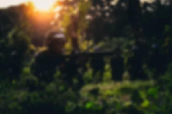 Blurry background soldier maneuver with machine gun — Stock Photo, Image