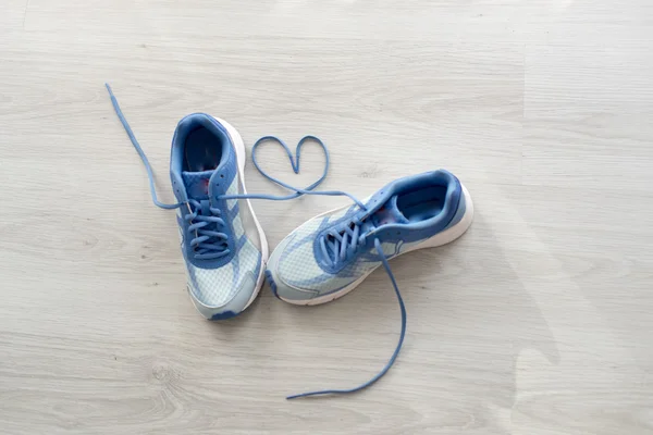 Love sign, Selective focus close up blue sport shoes on gray flo — Stock Photo, Image