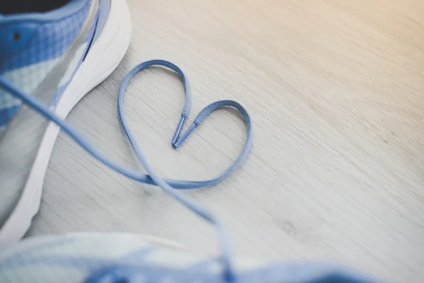 Love sign, Selective focus close up blue sport shoes on gray flo — Stock Photo, Image