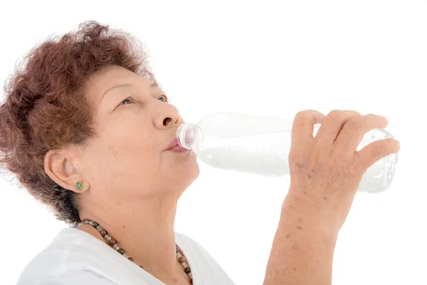 Senior woman drinks water from a bottle — Stock Photo, Image