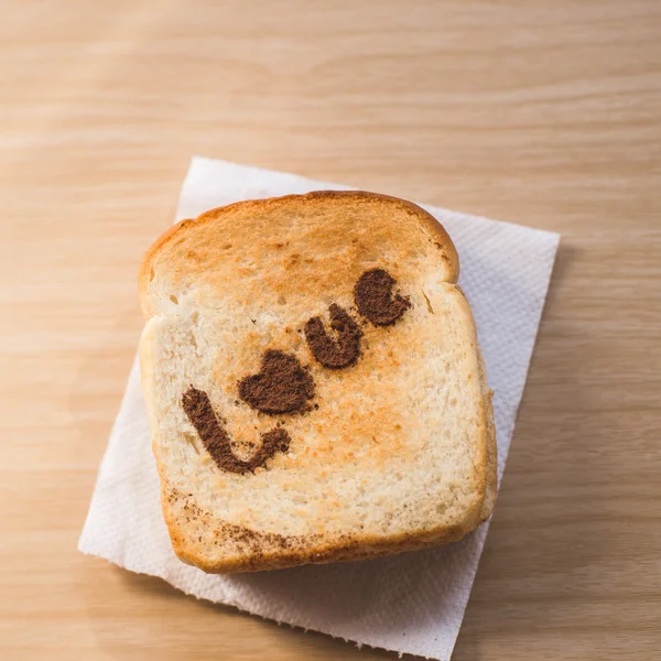 Love message on Bread sliced on wooden background. — Stock Photo, Image