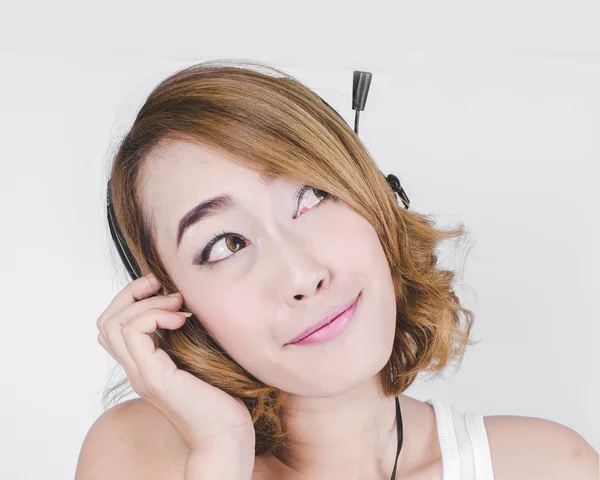 Happy Asian woman using headphone listening music on gray backgr — Stock Photo, Image