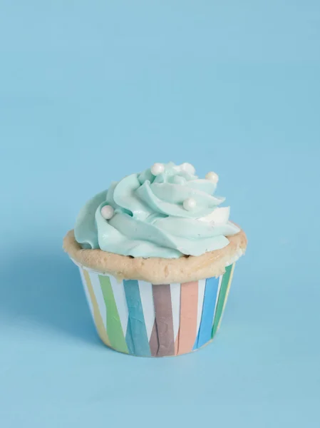 Cupcake de aniversário de pérolas com creme de manteiga em fundo pastel azul . — Fotografia de Stock