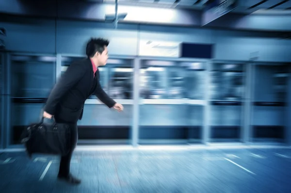 Motion blur Asian businessman in a subway — Stock Photo, Image