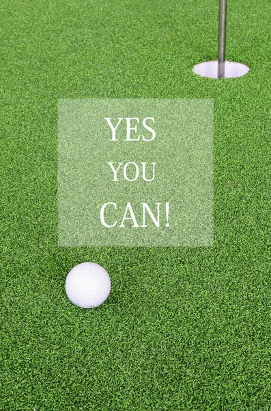 Golf ball and hole with word yes you can for inspiration — Stockfoto