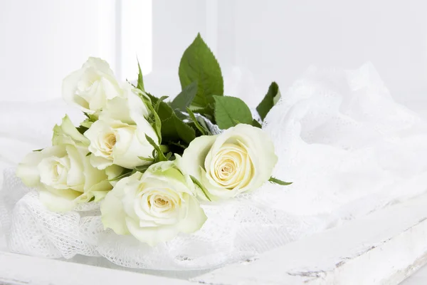 Five white roses on lace — Stock Photo, Image