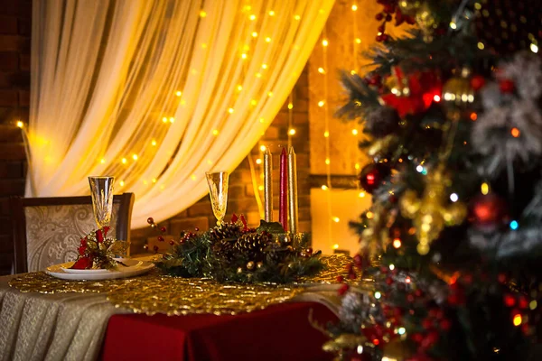 Christmas interior of the dark living room of the house. Christmas tree, lights of garlands on the walls, library Cabinet, books on the shelves. Luxury interior. New Year, red and gold balls.