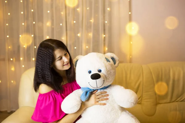 Happy Girl Pink Dress Hugging Big White Soft Bear Home — Stock Photo, Image