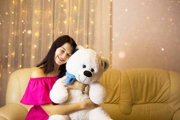 Happy Girl Pink Dress Hugging Big White Soft Bear Home — Stock Photo, Image