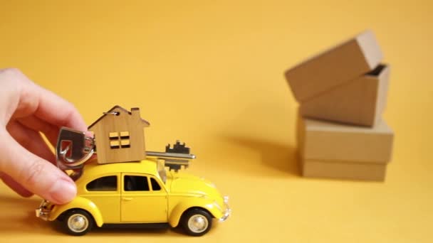 Yellow Toy Car Key House Roof Goes Illuminating Background Packing — Stock Video