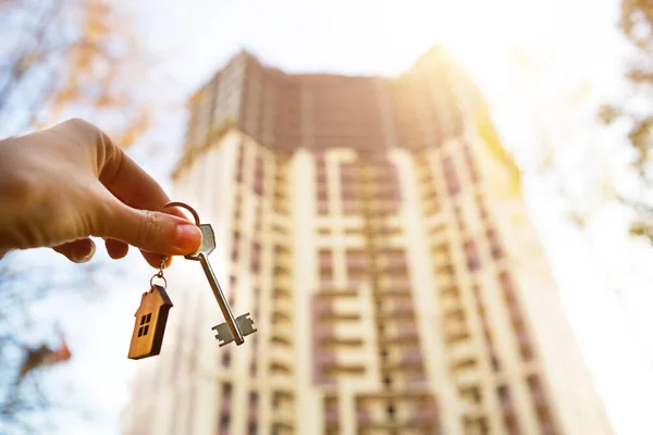 Hand Key Wooden Key Ring House Background Multi Apartment Skyscraper Stock Picture