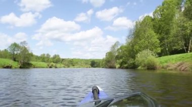 The nose of a kayak on the river-rafting on a sports boat, view from the water. Water hiking, domestic tourism, unity with nature, ecotourism, active recreation, healthy lifestyle, fishing.
