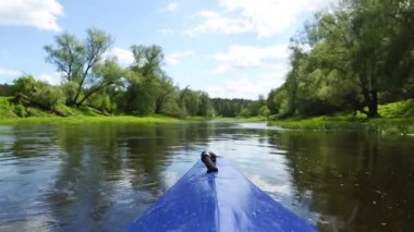 The nose of a kayak on the river-rafting on a sports boat, view from the water. Water hiking, domestic tourism, unity with nature, ecotourism, active recreation, healthy lifestyle, fishing.