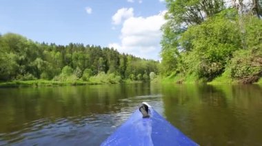 The nose of a kayak on the river-rafting on a sports boat, view from the water. Water hiking, domestic tourism, unity with nature, ecotourism, active recreation, healthy lifestyle, fishing.