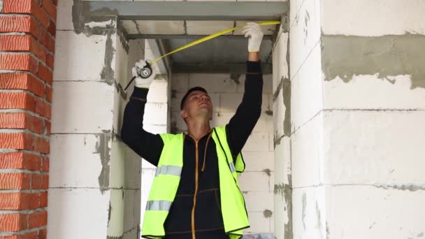 Construction Worker Construction Site Measures Length Window Opening Brick Wall — Stock Video