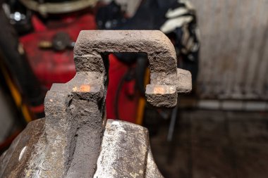 Pasla kaplı fren kalibresi temizlik için mengeneye yerleştirilmiş..