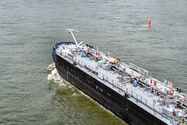 A large barge for the transport of liquid fuels sailing in Germany on the Rhine River. Transportation of oil, gas and gasoline, top view.