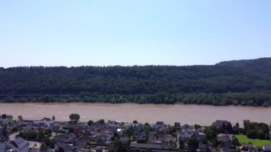 Aerial view of the River Rhine and the hills of a winery in western Germany and a small village in between.